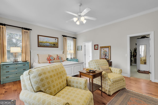 bedroom with ceiling fan, light hardwood / wood-style floors, and crown molding