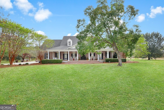 cape cod house with covered porch and a front lawn