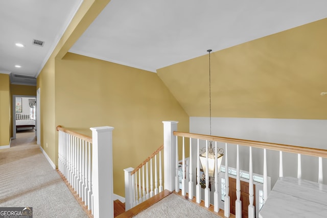 stairs with carpet flooring, an inviting chandelier, and lofted ceiling