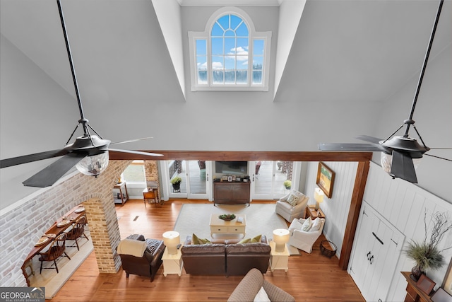 living room featuring hardwood / wood-style flooring, a wealth of natural light, and ceiling fan