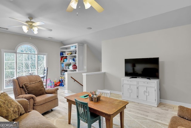 living room with ceiling fan, light hardwood / wood-style floors, and lofted ceiling