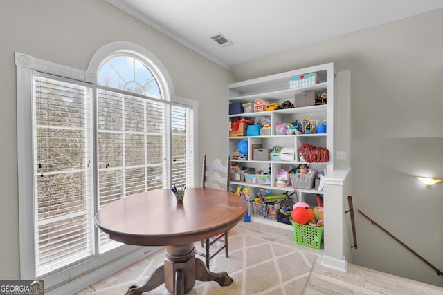 dining room featuring hardwood / wood-style flooring and crown molding