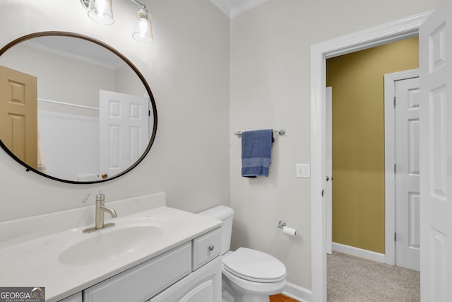 bathroom with vanity, toilet, and crown molding