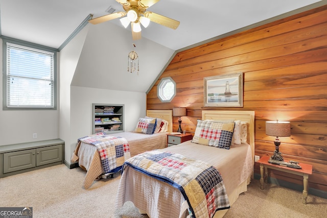 carpeted bedroom featuring ceiling fan, wooden walls, and vaulted ceiling