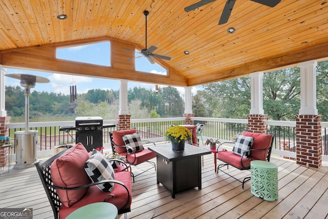 wooden terrace with ceiling fan and area for grilling