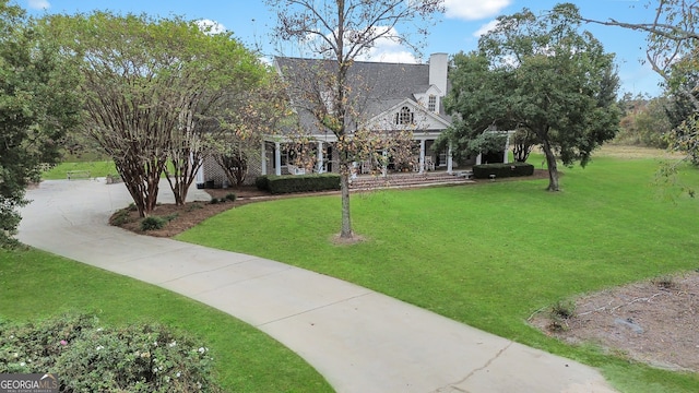 cape cod house with a front lawn