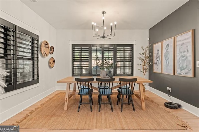 dining room with hardwood / wood-style flooring and a chandelier