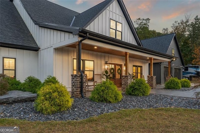 property exterior at dusk with covered porch