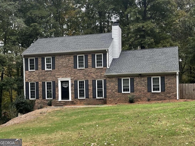 colonial home featuring a front yard