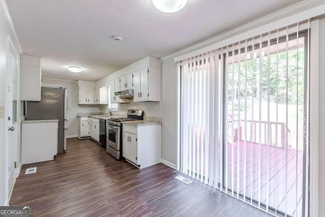 6275 S Skyline Dr, Douglasville, GA 30135 - kitchen with white cabinets, stainless steel appliances, baseboards, under cabinet range hood, and visible vents