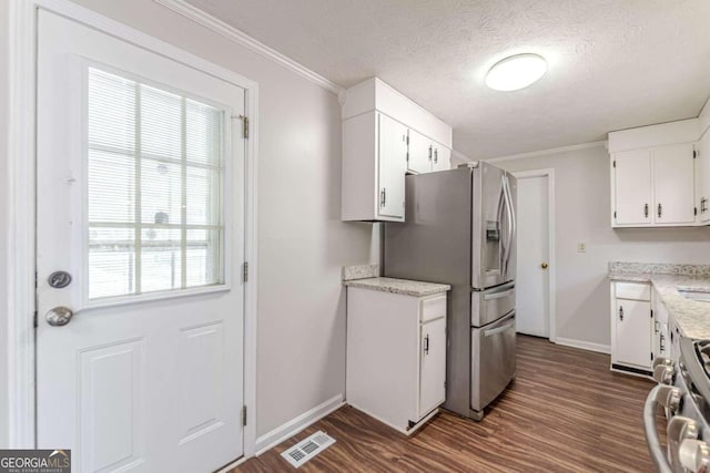 kitchen with white cabinetry, crown molding, appliances with stainless steel finishes, and dark hardwood / wood-style flooring