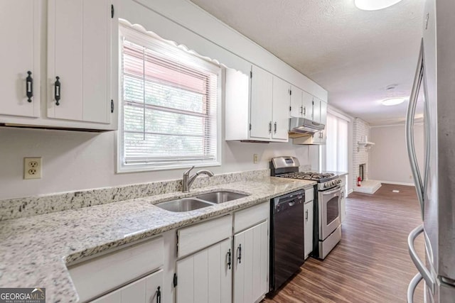 kitchen featuring light stone counters, white cabinetry, dark wood-type flooring, sink, and stainless steel appliances