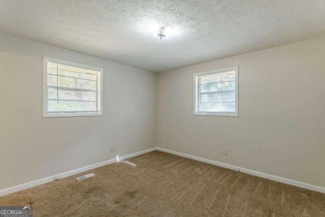 6275 S Skyline Dr, Douglasville, GA 30135 - empty room with visible vents, a textured ceiling, carpet, and baseboards