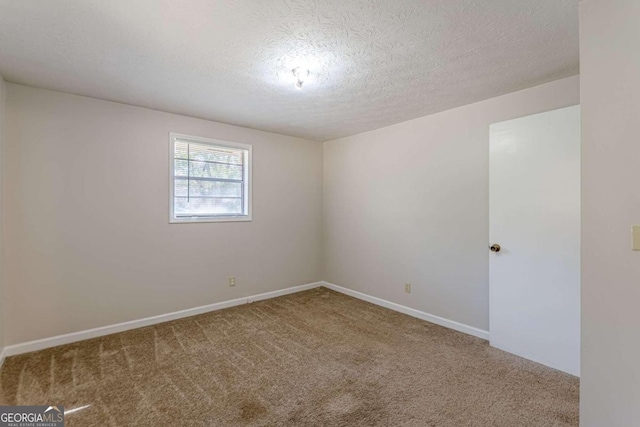 spare room featuring a textured ceiling and carpet floors