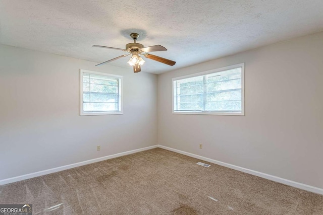 6275 S Skyline Dr, Douglasville, GA 30135 - carpeted spare room with baseboards, ceiling fan, a textured ceiling, and visible vents