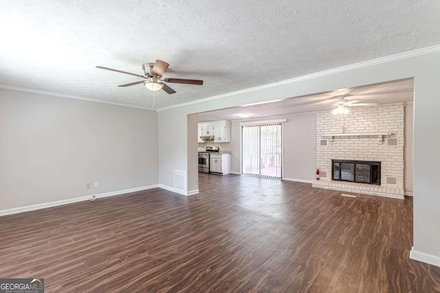 unfurnished living room with dark wood-type flooring, ornamental molding, a brick fireplace, a textured ceiling, and ceiling fan