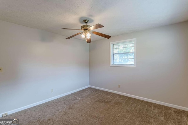 unfurnished room with a textured ceiling, carpet flooring, and ceiling fan