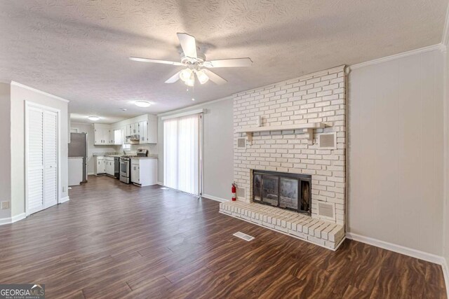 6275 S Skyline Dr, Douglasville, GA 30135 - unfurnished living room with baseboards, dark wood-type flooring, a textured ceiling, and ceiling fan