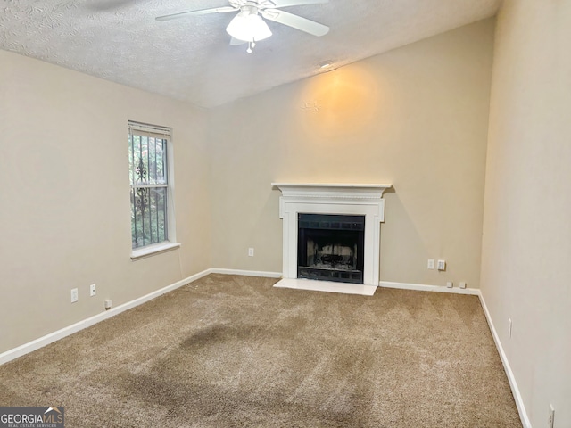 unfurnished living room featuring carpet, a textured ceiling, and ceiling fan