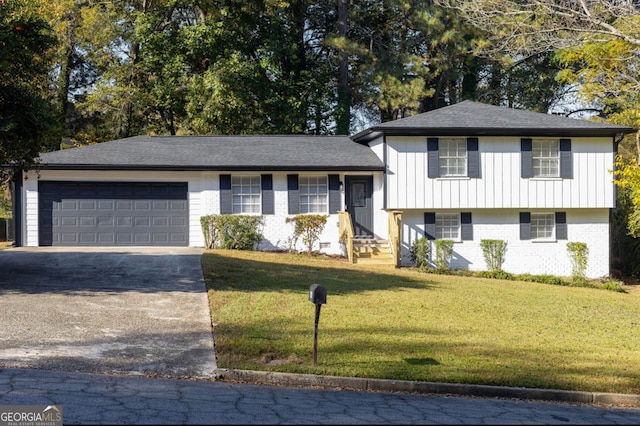 tri-level home with a garage and a front lawn