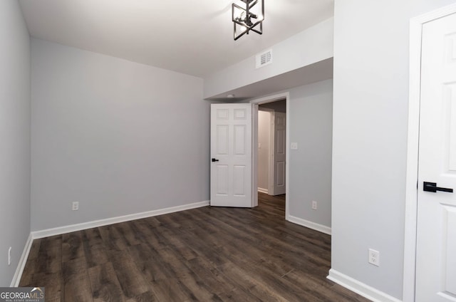 spare room with dark hardwood / wood-style flooring