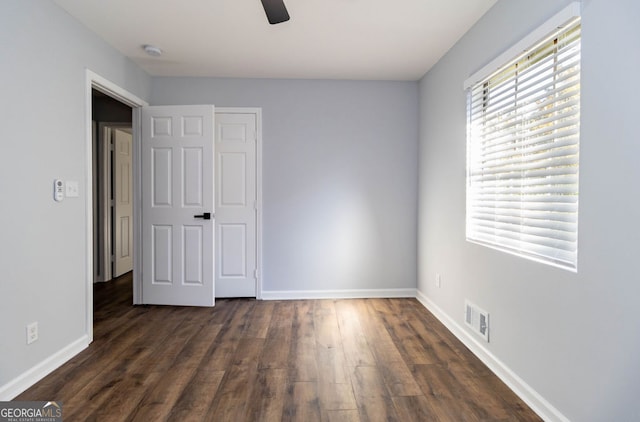 unfurnished bedroom with a closet, ceiling fan, and dark hardwood / wood-style floors