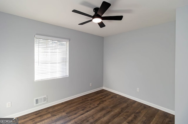 empty room with ceiling fan and dark hardwood / wood-style flooring