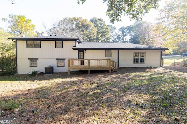 rear view of property with a wooden deck and central air condition unit