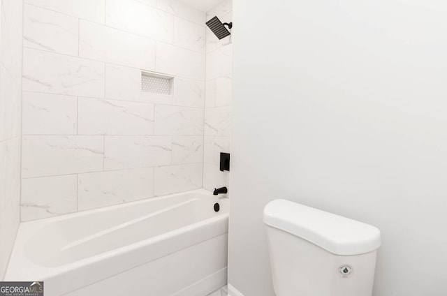 bathroom with toilet and tiled shower / bath combo