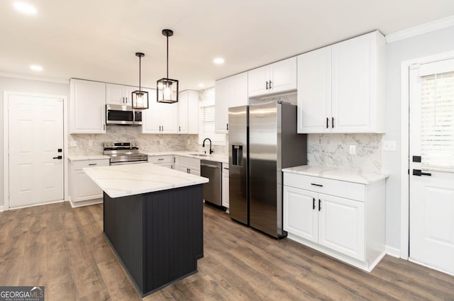 kitchen with a center island, white cabinetry, and stainless steel appliances