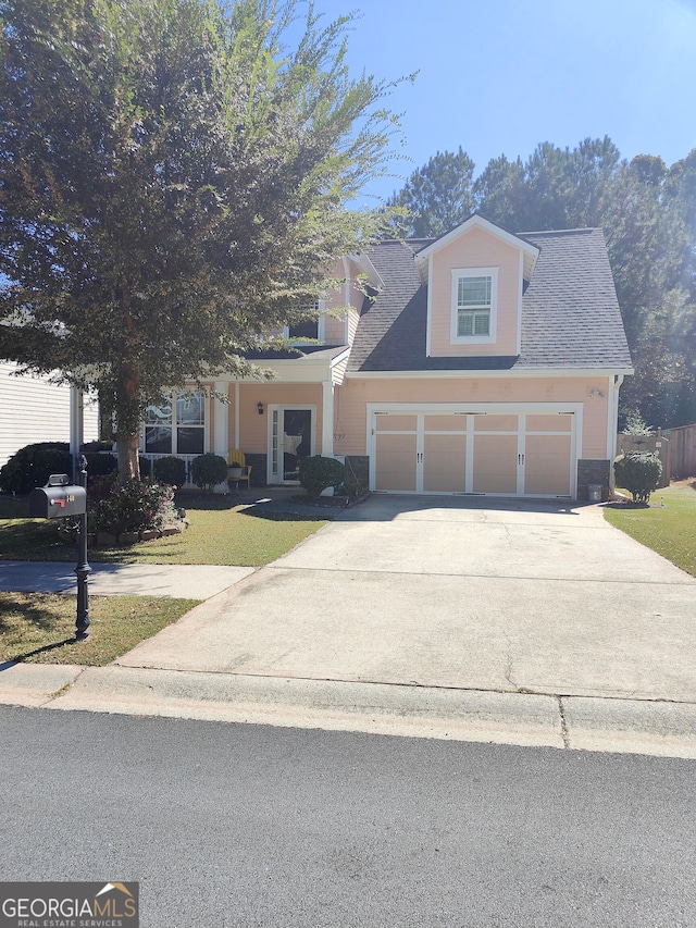 view of front of property featuring a front lawn and a garage