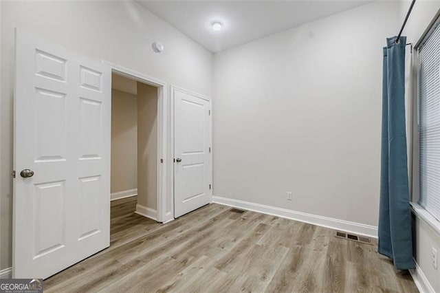 unfurnished bedroom featuring light wood-type flooring