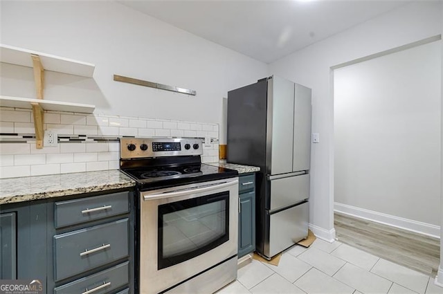 kitchen featuring gray cabinets, decorative backsplash, light hardwood / wood-style flooring, and stainless steel appliances