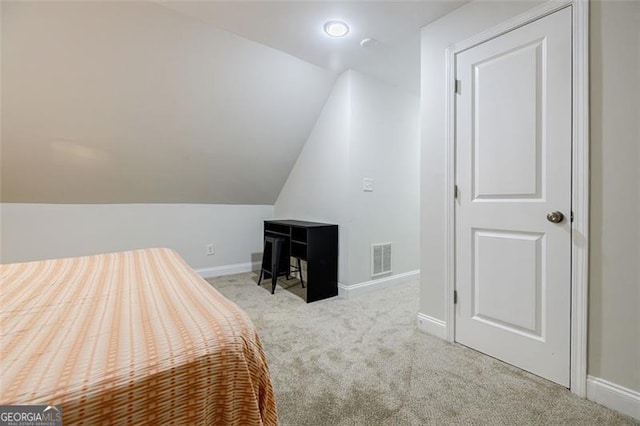 bedroom featuring lofted ceiling and light colored carpet