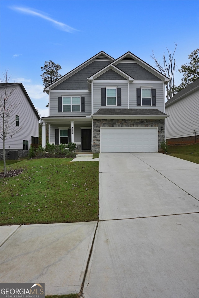 view of front of home with central AC unit, a garage, and a front lawn