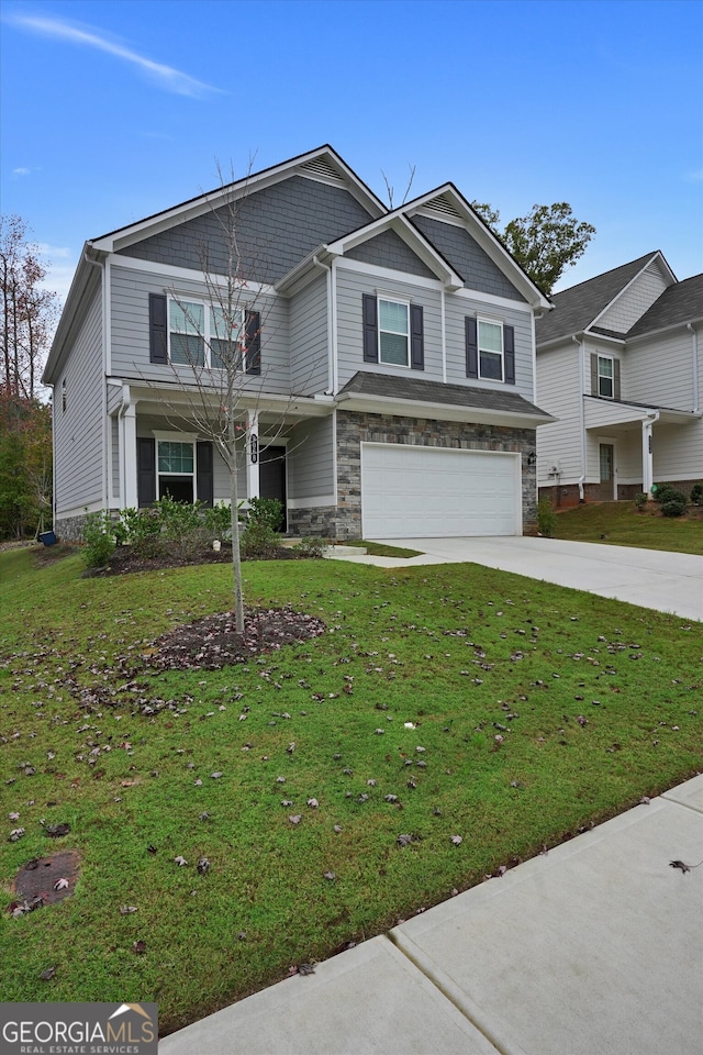 view of front of home with a front lawn and a garage