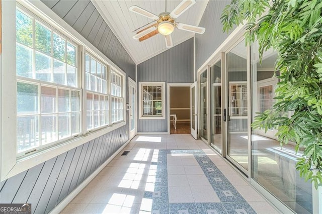 unfurnished sunroom featuring ceiling fan and vaulted ceiling