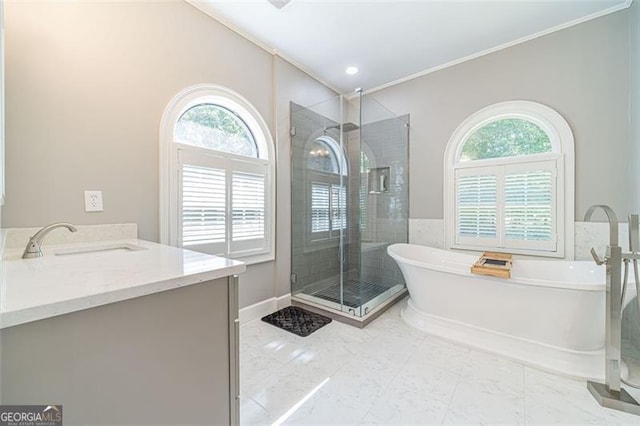 bathroom with separate shower and tub, vanity, and ornamental molding