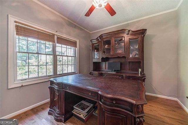 office space with ceiling fan, ornamental molding, and light wood-type flooring