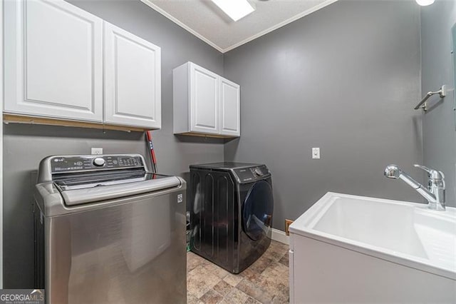 laundry area with washer and clothes dryer, crown molding, cabinets, and sink