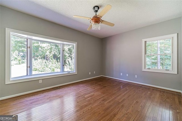 unfurnished room with hardwood / wood-style floors, ceiling fan, and a textured ceiling