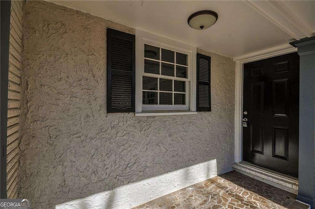 view of exterior entry featuring a porch