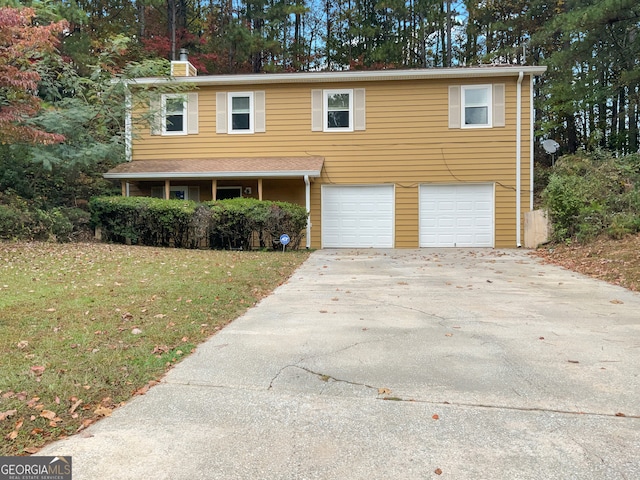 view of front of house featuring a front lawn and a garage