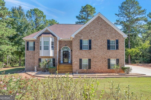 bi-level home with a front lawn