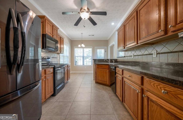 kitchen featuring decorative backsplash, hanging light fixtures, ornamental molding, black appliances, and light tile patterned flooring