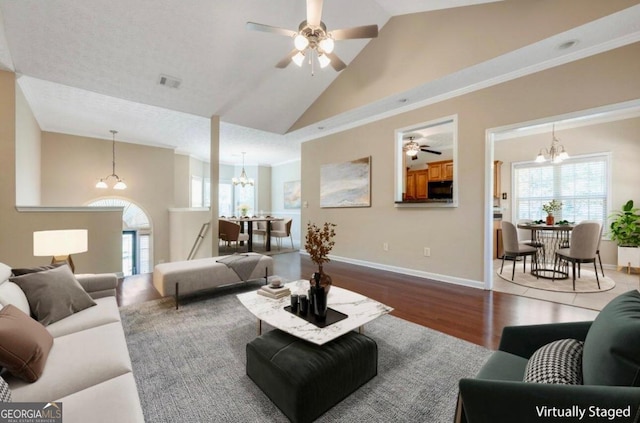 living room featuring high vaulted ceiling, a textured ceiling, ceiling fan with notable chandelier, and hardwood / wood-style floors