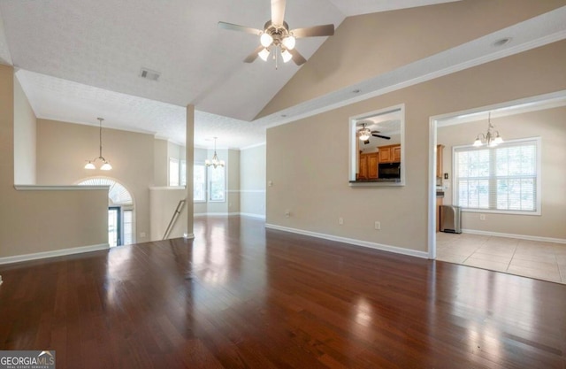 unfurnished living room with high vaulted ceiling, a textured ceiling, light hardwood / wood-style flooring, and ceiling fan with notable chandelier