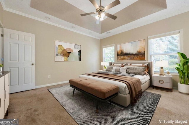 bedroom with crown molding, ceiling fan, multiple windows, and a raised ceiling