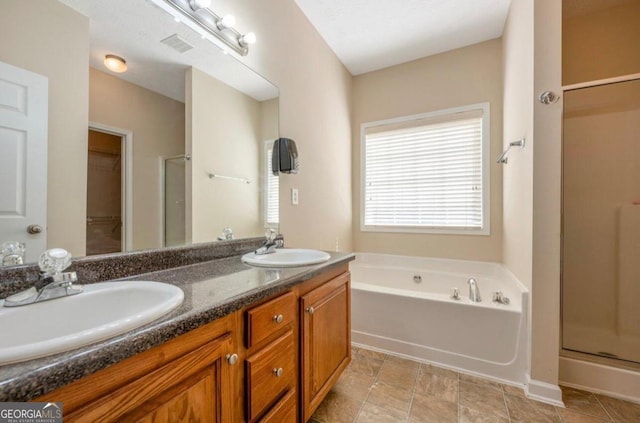 bathroom featuring vanity and plus walk in shower