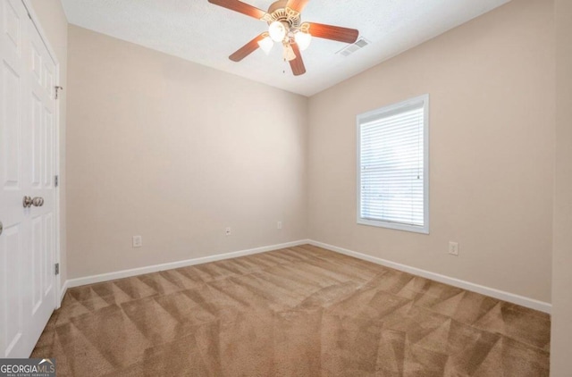 carpeted empty room with ceiling fan